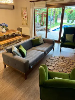 a living room with a couch and a table at Villa Luna Sapanca in Sakarya