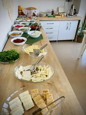 a table with several plates of cheese and other foods at Ağva Manolyam Otel in Sile
