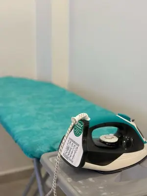 a phone sitting on a table next to a chair at Modern 2Bedroom Apt in Şişli in Istanbul