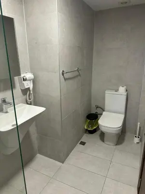 a bathroom with a toilet and a sink and a shower at Modern 2Bedroom Apt in Şişli in Istanbul
