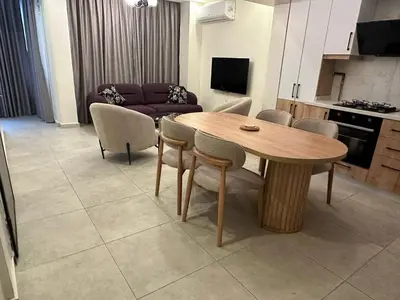 a living room with a wooden table and chairs at Modern 2Bedroom Apt in Şişli in Istanbul