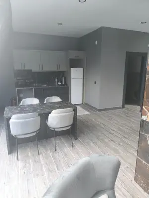 a living room with a table and chairs and a kitchen at Hilloria Tatil Köyü in Sapanca