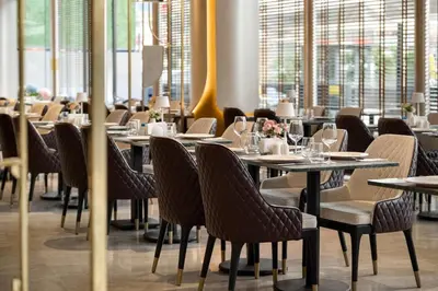 a dining room with tables and chairs and windows at Tryp by Wyndham Istanbul Beyoglu in Istanbul
