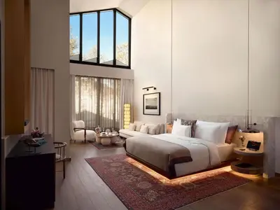 a bedroom with a large bed and a living room at Aliée Istanbul - A Paris Society Collection Hotel in Istanbul