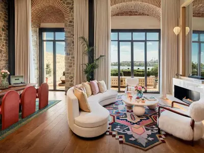 a living room with couches and a fireplace at Aliée Istanbul - A Paris Society Collection Hotel in Istanbul