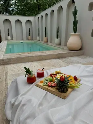 a plate of food on a table next to a pool at Saman Villas in Kadıköy