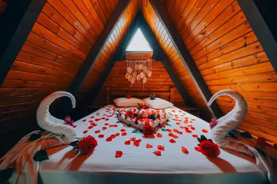 a bedroom with a bed with red roses on it at Maya Sapanca Bungalow in Sapanca
