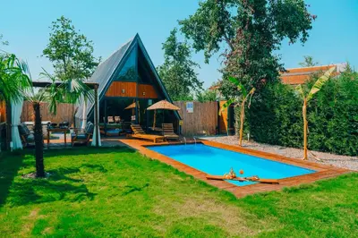 a swimming pool in a yard with a house at Maya Sapanca Bungalow in Sapanca