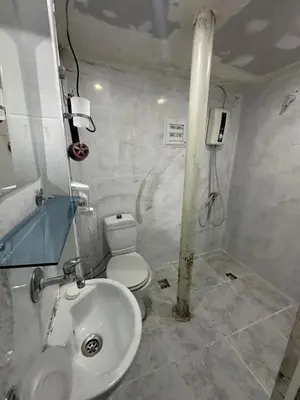 a bathroom with a white toilet and a sink at Ada Apart Otel in Istanbul