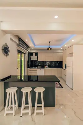 an open kitchen with a large island and stools at Villove Sapanca in Sapanca