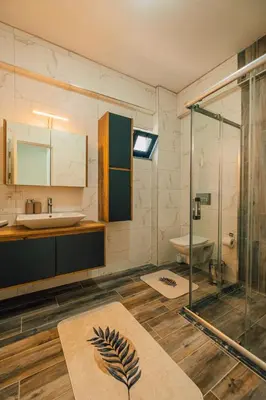 a bathroom with a glass shower and a sink at Villove Sapanca in Sapanca