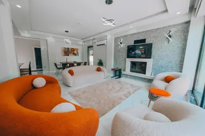 a living room with white furniture and a fireplace at Villove Sapanca in Sapanca