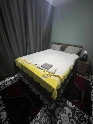 a bedroom with a bed with a yellow blanket on it at Murat bey konağı in Istanbul