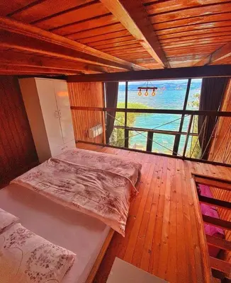 a bed in a room with a view of the ocean at Flamingo Sapanca in Sapanca