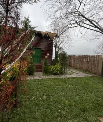 a log cabin in a yard with a fence at Flamingo Sapanca in Sapanca