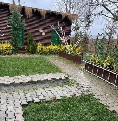 a garden with a brick path in front of a building at Flamingo aura in Sapanca