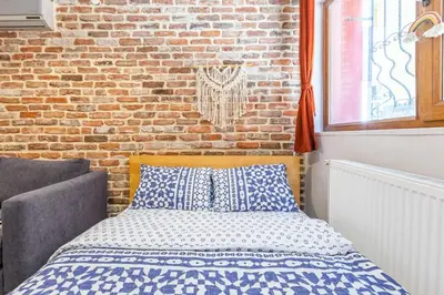 a bed in a room with a brick wall at Galata Hidden Apartments in Istanbul
