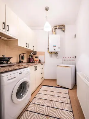 a white laundry room with a washer and dryer at Galata Hidden Apartments in Istanbul