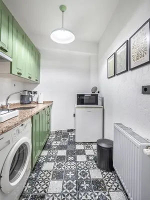 a kitchen with green cabinets and a washing machine at Galata Hidden Apartments in Istanbul