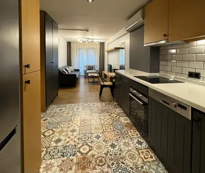 a kitchen with a counter and a living room at Gezgin Residence in Istanbul