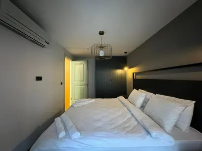 a bed with white sheets and pillows in a bedroom at Gezgin Residence in Istanbul