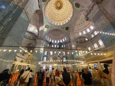 a group of people standing in a building with a chandelier at Blue Star Apartments Old City Center in Istanbul