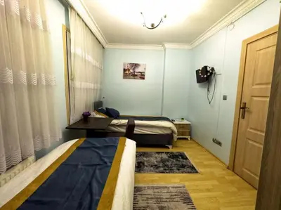 a room with two beds and a door and a room with a door at Blue Star Apartments Old City Center in Istanbul