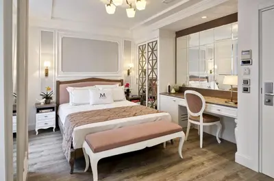 a bedroom with a bed and a desk and a mirror at Mirrors Hotel İstanbul Taksim City Center in Istanbul