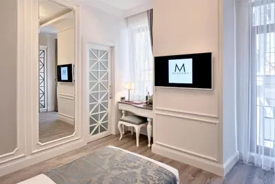 a dressing room with a mirror and a desk at Mirrors Hotel İstanbul Taksim City Center in Istanbul