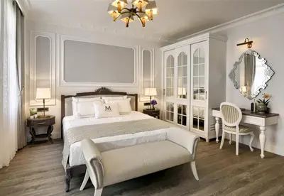 a bedroom with a bed and a table and a chair at Mirrors Hotel İstanbul Taksim City Center in Istanbul