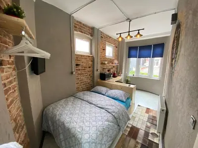 a bedroom with a bed and a brick wall at Hendec 7 Apartments Near Galataport in Istanbul
