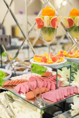 a bunch of appetizers on plates with a wine glass at Ruba Palace Thermal Hotel in Bursa