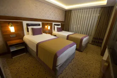 a hotel room with two beds in a room at Ruba Palace Thermal Hotel in Bursa