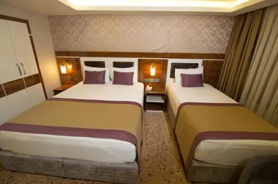 two beds in a hotel room with two at Ruba Palace Thermal Hotel in Bursa