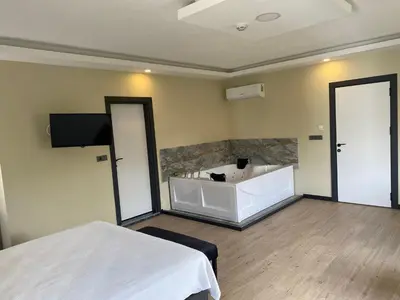 a room with a bath tub and two beds at Ağva Capella Hideaway Hotel in Sile