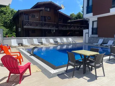 a patio with chairs and a table and a pool at Ağva Capella Hideaway Hotel in Sile