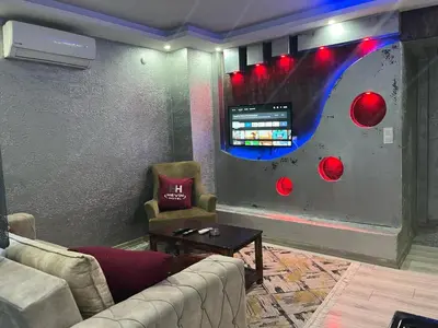 a living room with two couches and a tv at HEVİN Otel in Bursa