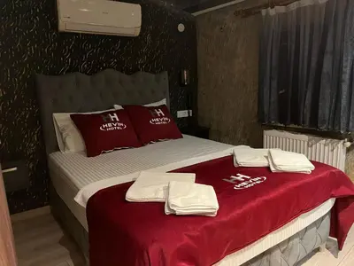a bed with red and white towels on it at HEVİN Otel in Bursa