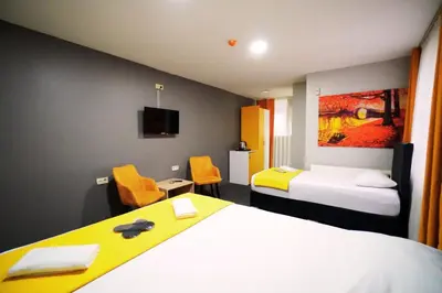 a hotel room with two beds and a tv at Polo Suit Otel in Avcılar