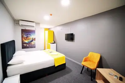 a hotel room with a bed and a chair at Polo Suit Otel in Avcılar