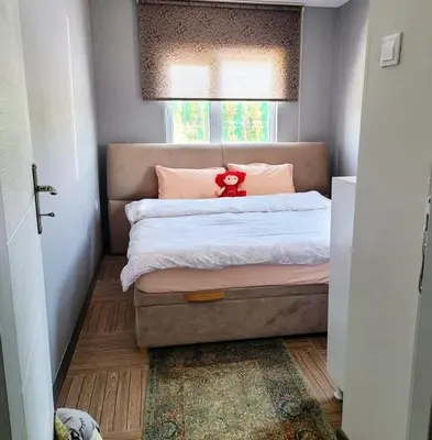 a bedroom with a bed with a red teddy bear on it at villa SM in Çatalca