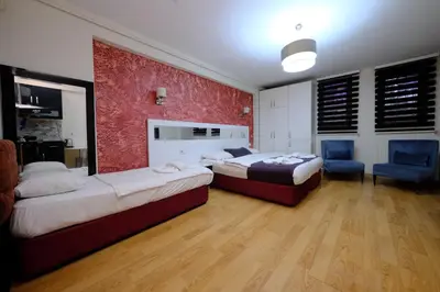 a bedroom with two beds and a blue chair at Taksim green suite in Istanbul