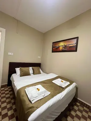 a hotel room with two beds with towels on them at Fındık Palas Otel in Istanbul