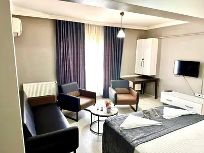 a hotel room with a bed and a living room at My King Suit in Istanbul