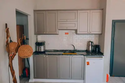 a kitchen with white cabinets and a white refrigerator at Flamingo Adalife in Sapanca