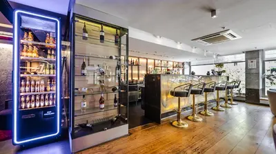 a bar with a row of stools in a room at Kent Hotel Beyazıt in Istanbul