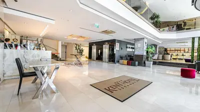 a store lobby with a table and a welcome mat on the floor at Kent Hotel Beyazıt in Istanbul