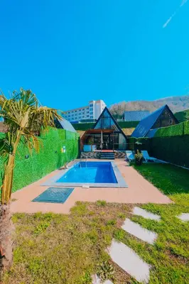 a swimming pool in a yard with a building at Mert Bungalov-Yıldız Evi in Sapanca