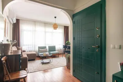 a room with a green door and a living room at Chic 2BR Gem on Moda Iconic Antiques Street in Istanbul