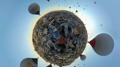 a group of kites flying in the sky at Zenith Göreme in Istanbul